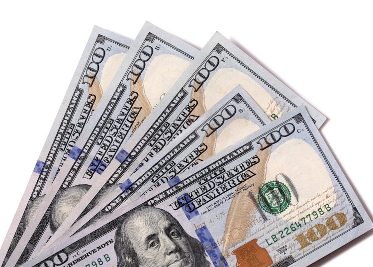 شوف وصل كام سعر الدولار اليوم 28 فبراير 2023 مقابل الجنيه المصري 1 Fan of $100 dollar bills isolated against white with shadow.