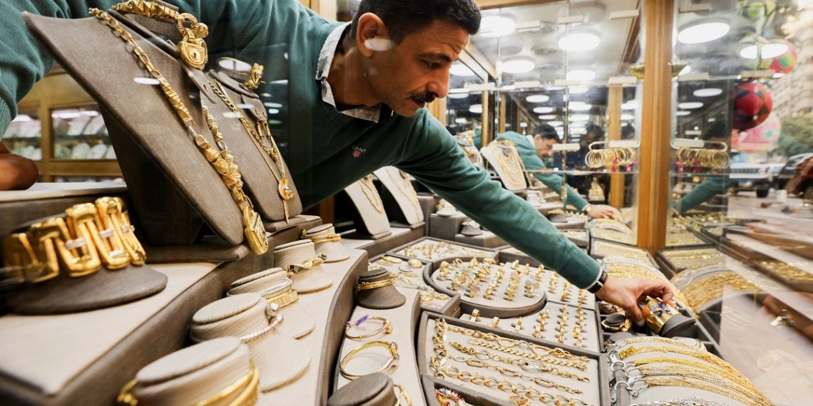 A gold vendor sorts jewellery pieces inside a shop at the gold market area, as gold prices recorded an increase after the latest devaluation of the local currency in Cairo, Egypt, December 8, 2022. REUTERS/Mohamed Abd El Ghany